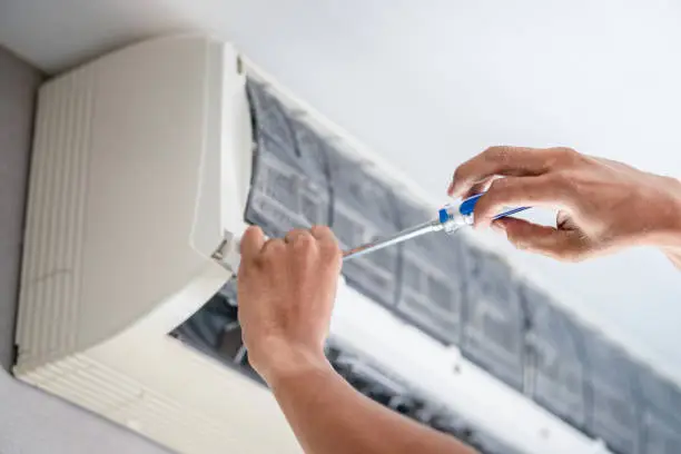 HVAC technician performing emergency air conditioning repair